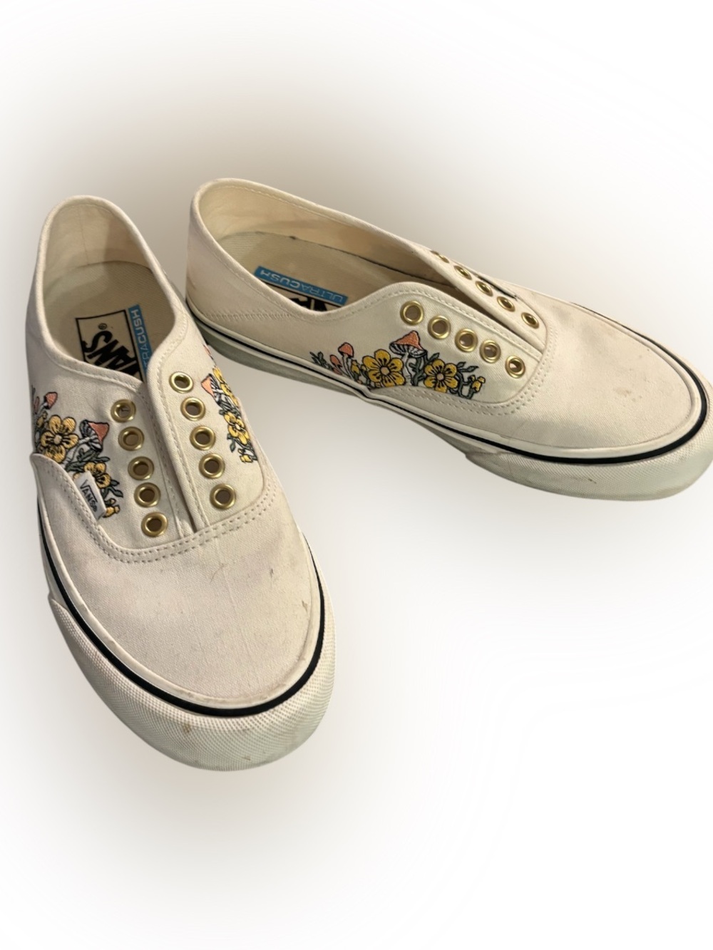 Vans Off-White Floral Slip-On Sneakers with Gold Eyelets